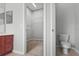 This bathroom features a toilet, sink, and walk in closet for storage at 1509 Cedar Lake Dr, Orlando, FL 32824