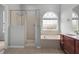 Bright bathroom features a tub, shower, and a large window for lots of light at 1509 Cedar Lake Dr, Orlando, FL 32824