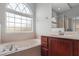 A relaxing bathroom with a large window above the bathtub for natural light at 1509 Cedar Lake Dr, Orlando, FL 32824