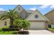 Attractive two-story home showcasing palm trees and a brick-accented facade at 1509 Cedar Lake Dr, Orlando, FL 32824