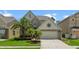Charming two-story home featuring lush landscaping, a two-car garage, and a welcoming entrance, nestled in a friendly neighborhood at 1509 Cedar Lake Dr, Orlando, FL 32824