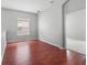 Neutral room with wood-look flooring, window, and entry door at 1509 Cedar Lake Dr, Orlando, FL 32824