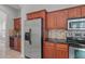 Stylish kitchen with stainless steel appliances, granite countertops, and wood cabinets, offering a modern and functional cooking space at 1509 Cedar Lake Dr, Orlando, FL 32824