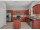 The kitchen offers wooden cabinets, stainless steel appliances, tile backsplash, black countertops, and a kitchen island at 1509 Cedar Lake Dr, Orlando, FL 32824