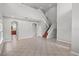 Open-concept living space with tile floors and a staircase, offering a versatile and inviting area for relaxation and entertainment at 1509 Cedar Lake Dr, Orlando, FL 32824