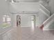 Bright and airy living area with tile flooring, a staircase, and large windows, creating a comfortable and welcoming atmosphere at 1509 Cedar Lake Dr, Orlando, FL 32824
