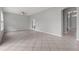 A light-filled living room with tile floors, neutral walls, and glass doors to office at 1509 Cedar Lake Dr, Orlando, FL 32824
