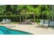 Relax and enjoy the pool with shaded pergola seating and nearby lounge chairs at 1509 Cedar Lake Dr, Orlando, FL 32824