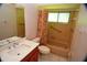 Bathroom with vanity, toilet and tub featuring updated fixtures at 1509 Huntington St, Deltona, FL 32725