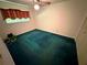 This bedroom features a ceiling fan and window with red curtains and an aqua carpet at 1509 Huntington St, Deltona, FL 32725
