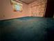 Spacious bedroom featuring an aqua carpet, bright window, and floral curtains at 1509 Huntington St, Deltona, FL 32725