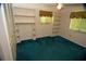 Bedroom with closet, built-in shelving, window and an aqua colored carpet at 1509 Huntington St, Deltona, FL 32725