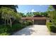 A well-maintained house with a long driveway leading to a two-car garage at 1509 Huntington St, Deltona, FL 32725