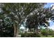 This home is nestled among mature trees with lush landscaping in the front yard at 1509 Huntington St, Deltona, FL 32725