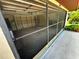 Screened-in garage showcasing interior with shelving and a well-lit space at 1509 Huntington St, Deltona, FL 32725