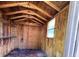 Interior view showcasing the wooden walls, shelf and ceiling beams of the shed structure at 1509 Huntington St, Deltona, FL 32725