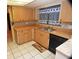 A kitchen featuring wood cabinets, black appliances and bright, natural light at 1509 Huntington St, Deltona, FL 32725