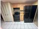 A kitchen boasting updated black appliances and wood cabinets for plenty of storage space at 1509 Huntington St, Deltona, FL 32725