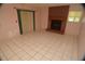 Tile-floored living room offers backyard views and a red-brick fireplace for cozy ambience at 1509 Huntington St, Deltona, FL 32725