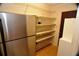 Pantry featuring stainless steel fridge and wire shelves at 1509 Huntington St, Deltona, FL 32725