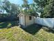 Exterior view of shed set in a fenced in backyard at 1509 Huntington St, Deltona, FL 32725