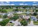 Aerial view of a gray home nestled in a lush, green neighborhood at 16053 Wilkinson Dr, Clermont, FL 34714