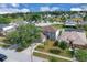 Aerial view of a gray home nestled in a lush, green neighborhood at 16053 Wilkinson Dr, Clermont, FL 34714