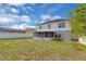 Backyard with mature tree, grass, white vinyl fencing, and screened-in porch at 16053 Wilkinson Dr, Clermont, FL 34714