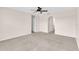 Expansive bedroom with carpeted flooring, doorway, and arched entryway enhancing accessibility at 16053 Wilkinson Dr, Clermont, FL 34714