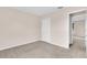 Spacious bedroom with carpeted flooring, a closet, and a doorway visible in the photograph at 16053 Wilkinson Dr, Clermont, FL 34714