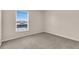 Cozy bedroom with carpet and a window offering a view of the outdoors with blinds at 16053 Wilkinson Dr, Clermont, FL 34714