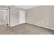 A clean, carpeted bedroom featuring a closet and an open doorway to another room at 16053 Wilkinson Dr, Clermont, FL 34714