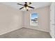 This bedroom features a ceiling fan and a window to provide fresh air and natural light at 16053 Wilkinson Dr, Clermont, FL 34714