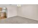Bright empty room with neutral paint and carpeting, adjacent to kitchen at 16053 Wilkinson Dr, Clermont, FL 34714