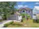 Two-story home with landscaped lawn and attached two-car garage at 16053 Wilkinson Dr, Clermont, FL 34714