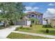 Two-story home with landscaped lawn and attached two-car garage at 16053 Wilkinson Dr, Clermont, FL 34714