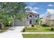 Two-story home with landscaped lawn and attached two-car garage at 16053 Wilkinson Dr, Clermont, FL 34714