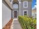 Pathway leading to front door and arched window on a two-story home at 16053 Wilkinson Dr, Clermont, FL 34714