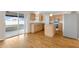 Kitchen with wood-look floors, island, stainless steel refrigerator, and sliding glass door to the porch at 16053 Wilkinson Dr, Clermont, FL 34714