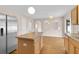 Bright kitchen with center island, wood-look floors, and stainless-steel refrigerator at 16053 Wilkinson Dr, Clermont, FL 34714
