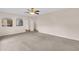 Large living room with neutral carpet and arches into the kitchen and entrance at 16053 Wilkinson Dr, Clermont, FL 34714