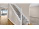 Staircase with white railing and carpeted stairs in a bright entryway at 16053 Wilkinson Dr, Clermont, FL 34714