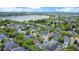 Expansive aerial shot of homes with pools and lush landscaping near a tranquil lake at 1636 Hanks Ave, Orlando, FL 32814