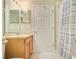 Bathroom with vanity, sink, mirror, and shower-tub combo with a neutral colored shower curtain at 1636 Hanks Ave, Orlando, FL 32814