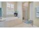 Bright bathroom featuring a soaking tub, a separate glass shower, and natural light at 1636 Hanks Ave, Orlando, FL 32814