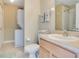 Cozy bathroom with a shower, a toilet, a sink, towels, and a stacked washer and dryer set at 1636 Hanks Ave, Orlando, FL 32814