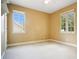 Neutral bedroom with two large windows and plush carpeting provides ample space and natural light at 1636 Hanks Ave, Orlando, FL 32814