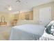 Bright bedroom features a ceiling fan, carpet flooring, a rocking chair, and a large bed with a blue comforter at 1636 Hanks Ave, Orlando, FL 32814