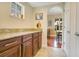 Convenient Butler Pantry with granite countertops, wood cabinets, and easy access to the dining area at 1636 Hanks Ave, Orlando, FL 32814