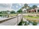 Scenic view of a wooden boardwalk over a tranquil lake, surrounded by community shops at 1636 Hanks Ave, Orlando, FL 32814